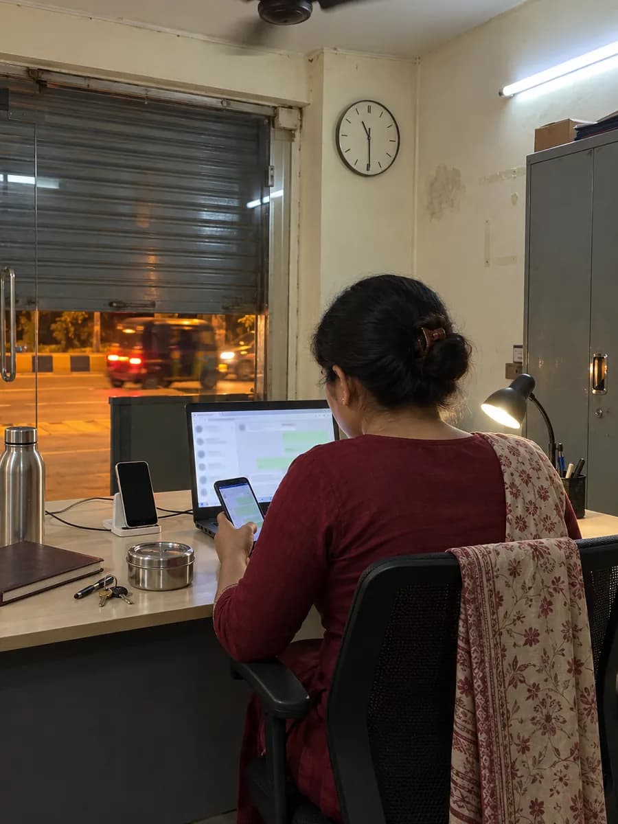 Booking desk at night in Andheri West, Mumbai, where a team member answers WhatsApp messages