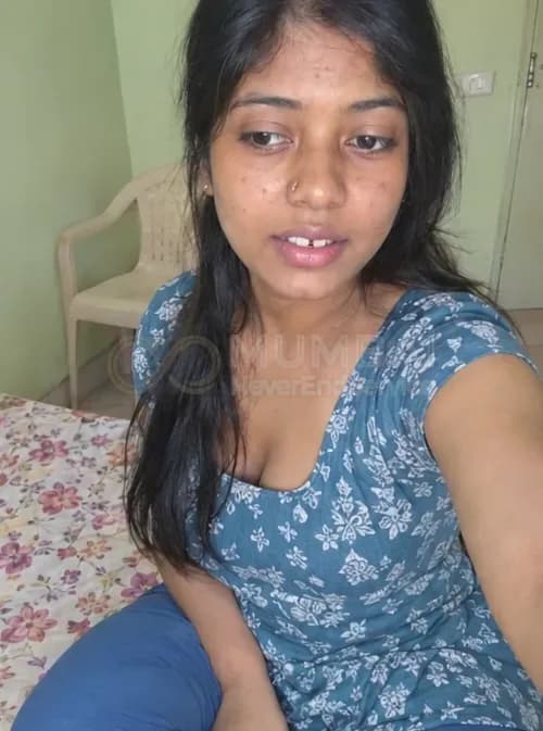 Cheap escort in Mumbai in a blue cotton kurti taking a selfie in a simple room
