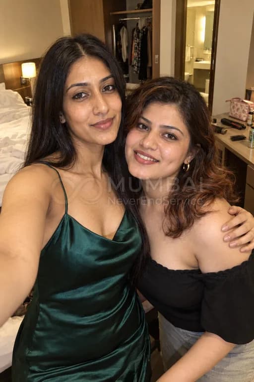 Two girls taking a selfie together in a Mumbai hotel room before going out, threesome escorts