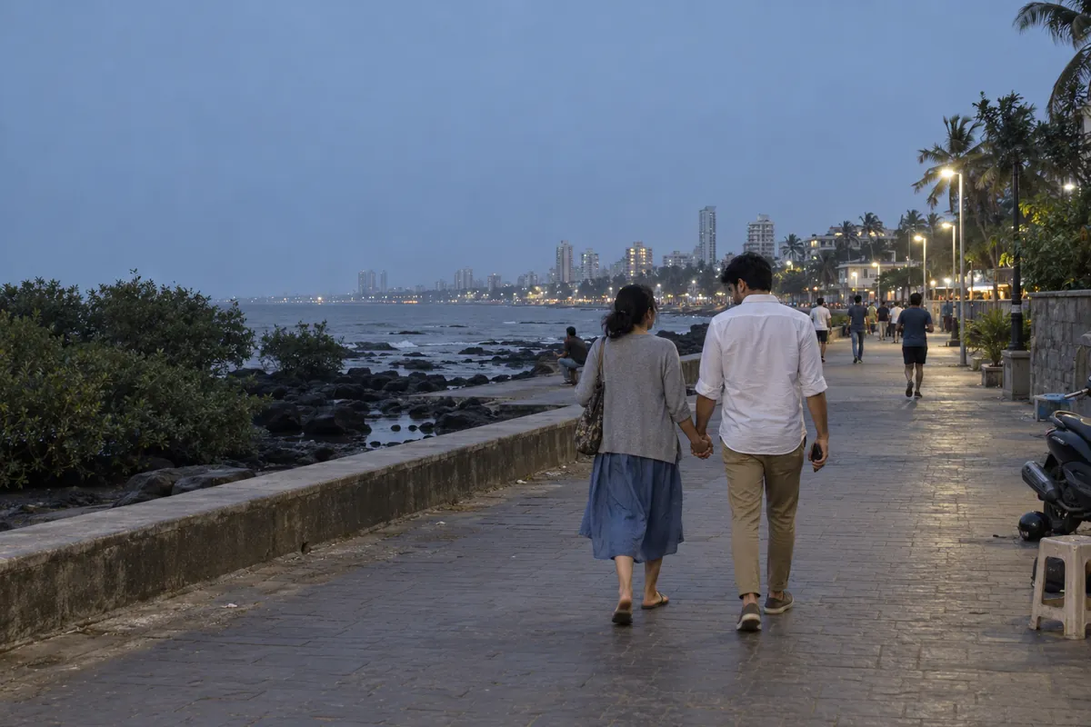 A couple holding hands on an evening walk along the Carter Road promenade in Bandra