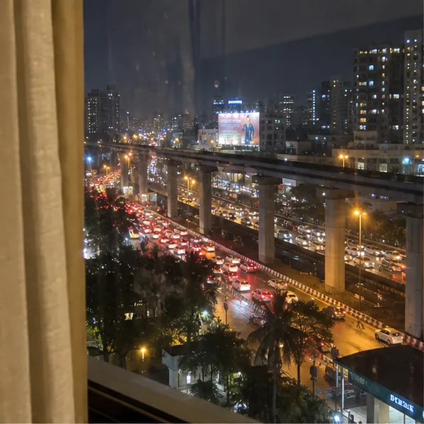 View from a hotel window in Andheri East at night, while a client books a call girl on WhatsApp