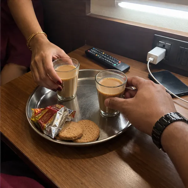Two glasses of cutting chai on a hotel room table, the call girl and the client together