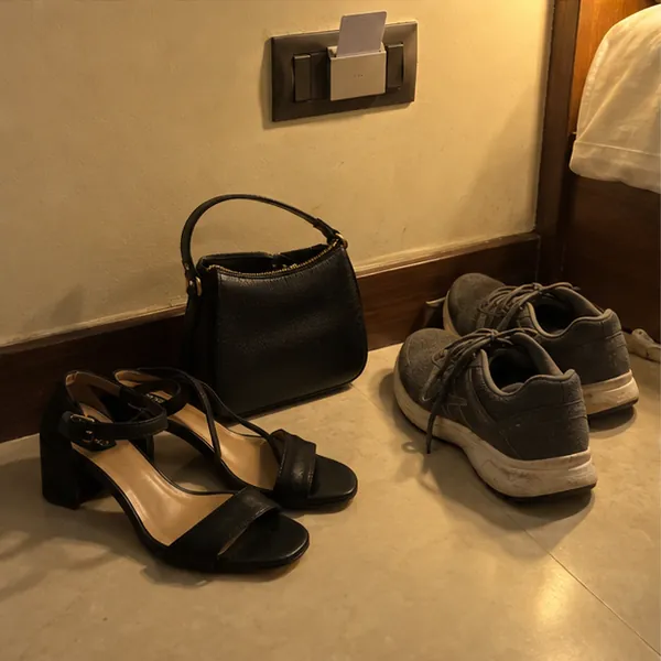 Her heels and handbag inside the hotel room door after she arrived